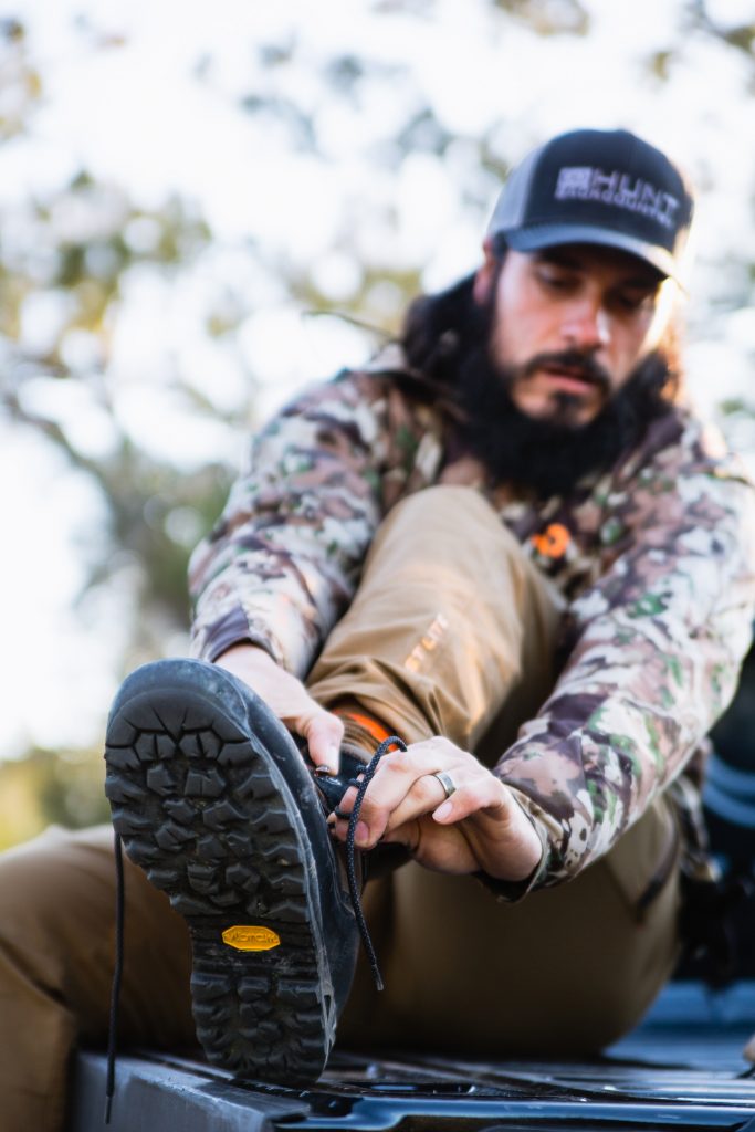 Josh from Dialed in Hunter putting on a pair of Crispi Wyoming GTX boots on a scouting trip in Arizona