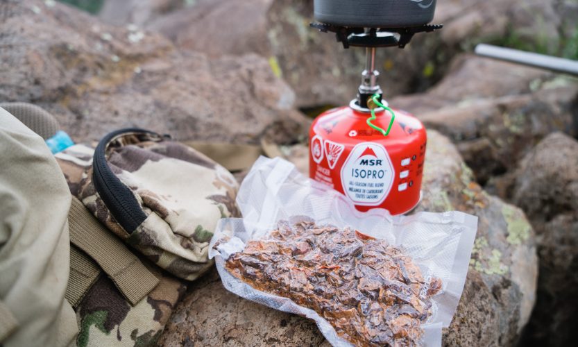 Josh from dialed in hunter's homemade bear chili on a bear hunt in arizona