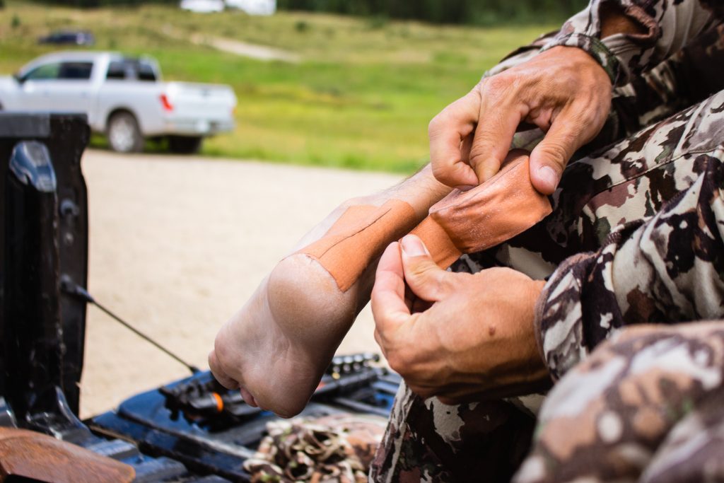 Josh Kirchner using leukotape on a backpack hunting trip to Colorado