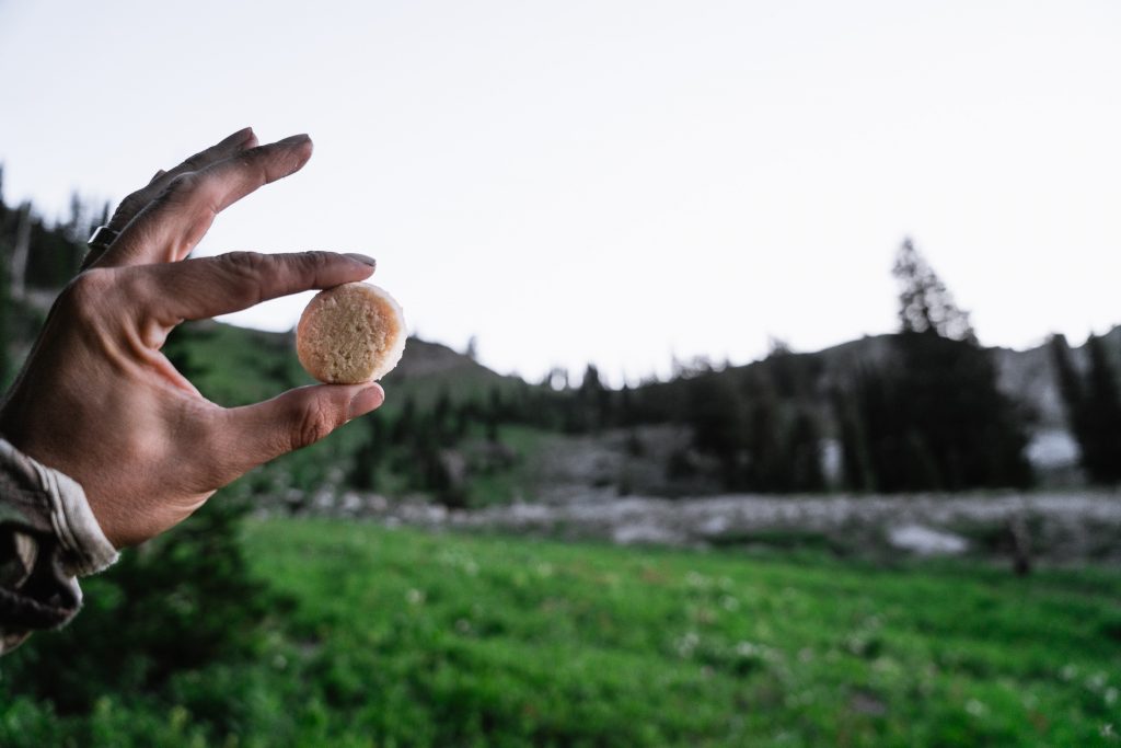 Josh Kirchner eating Heather's Choice Packaroons on a backpack hunting trip to Utah