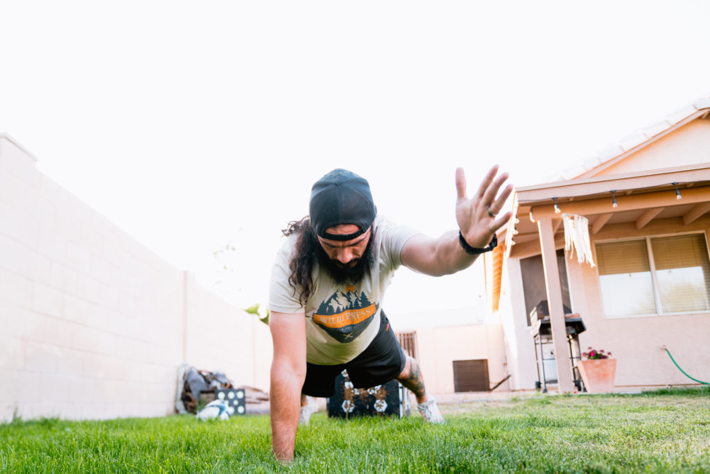 Josh Kirchner from Dialed in Hunter doing planked arm stretches for the wilderness athlete 28 day reboot 