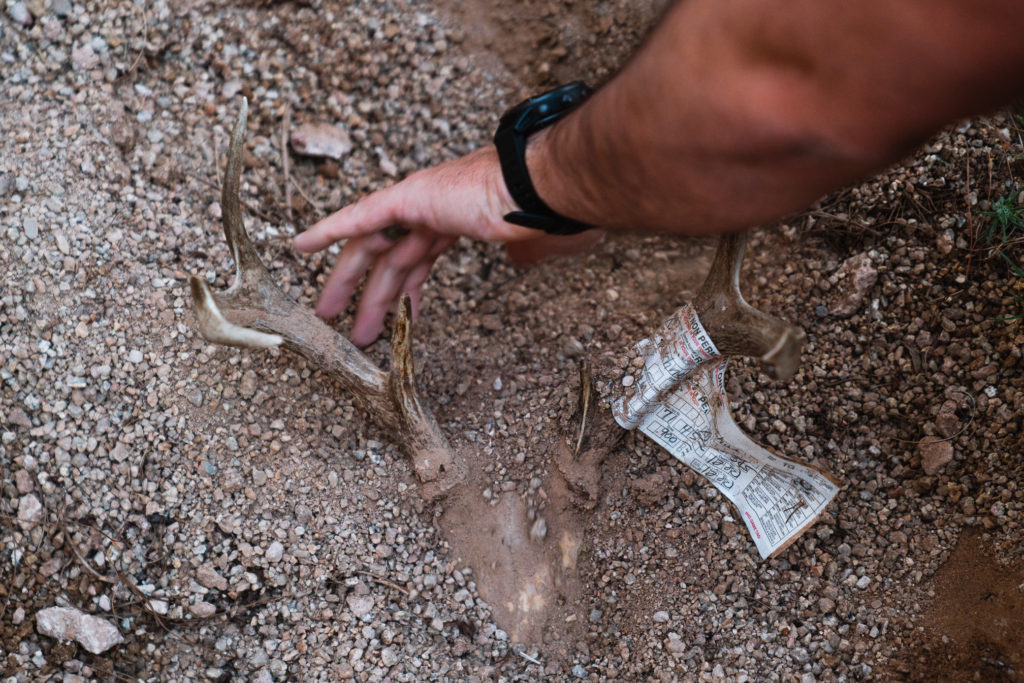 Josh burying a coues buck skull from a deer he shot with his bow