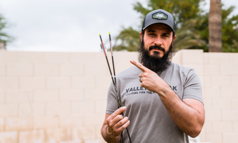 Josh Kirchner from Dialed in Hunter holding a bareshaft with fletched shaft