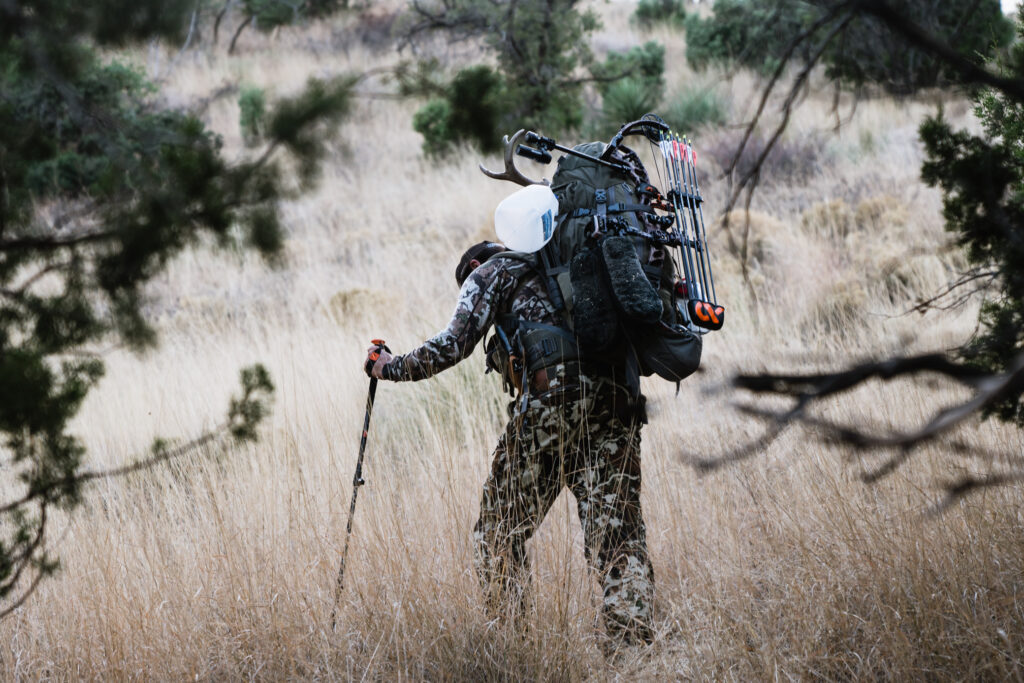 Josh Kirchner from Dialed in Hunter packing a coues buck out of the backcountry