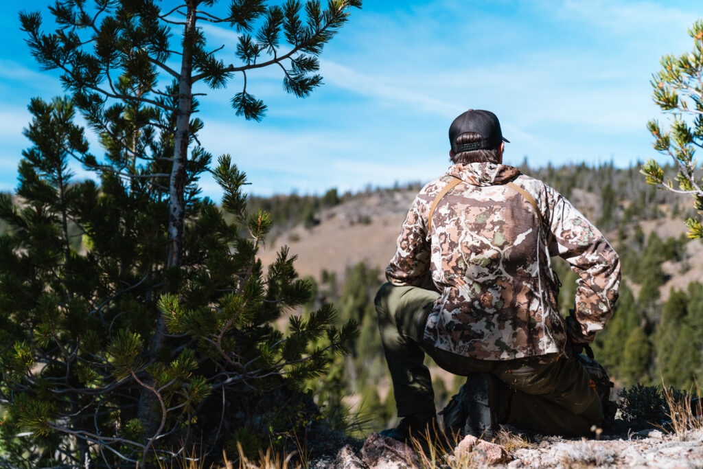 Kurtis Brooks looking over a vast basin and planning a stalk bowhunting for elk in Idaho