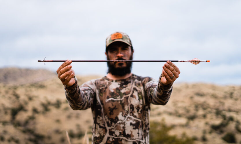 Josh Kirchner holding a Method Archery ZMR arrow after a successful coues deer hunt in Arizona