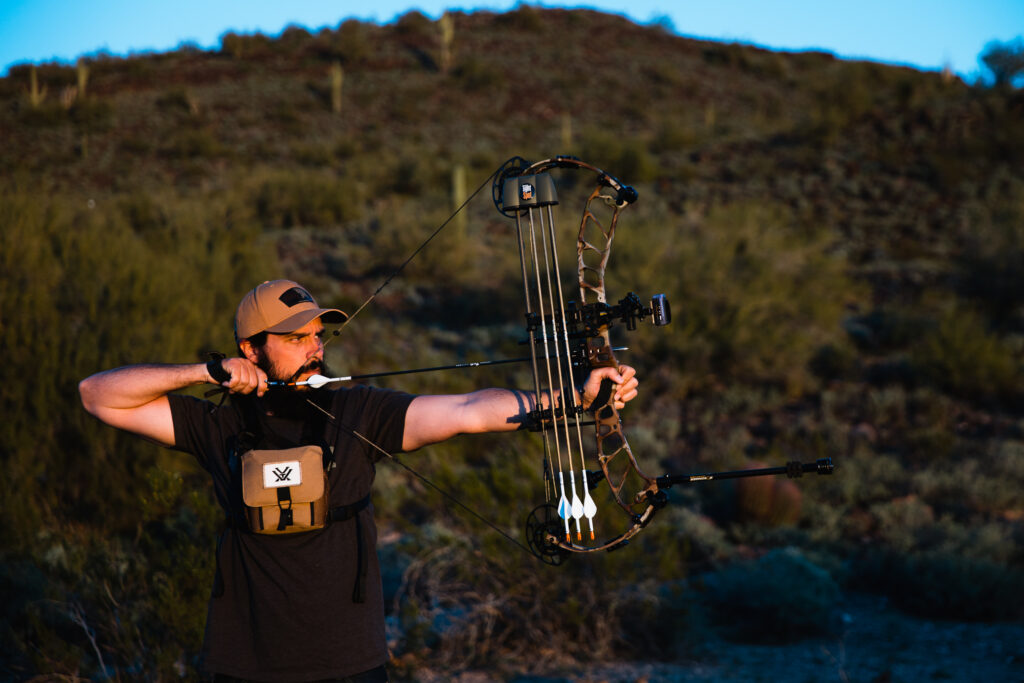 Josh Kirchner shooting his bow at the archery range