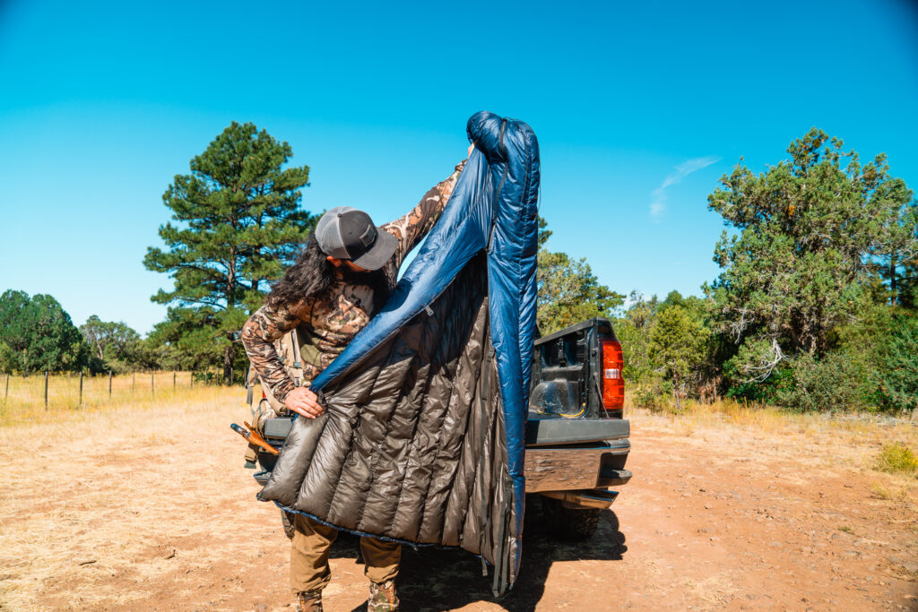 Josh Kirchner holds up the quilt he uses for early season backpack hunting