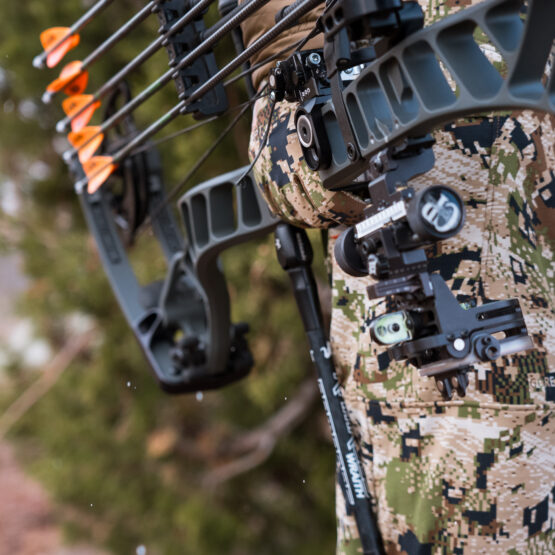 Josh Kirchner holding his bow on a coues deer hunt in Arizona