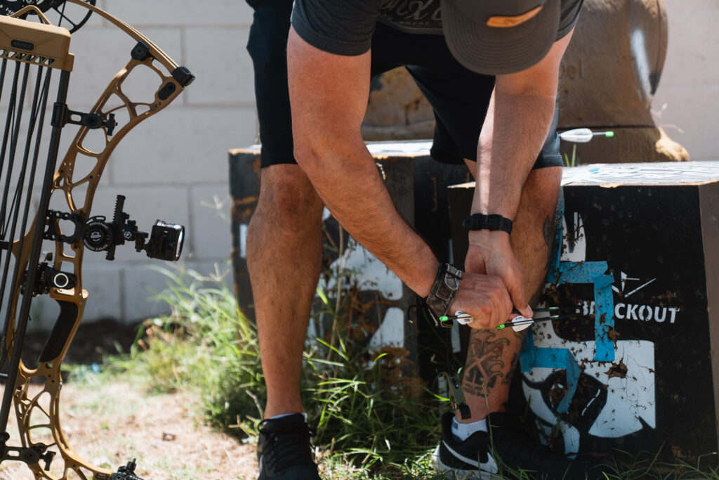 Josh Kirchner from Dialed in Hunter pulling arrows out of his target