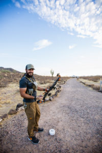 Josh of Dialed In Hunter laughing during a break at the archery range while practicing bowhunting.
