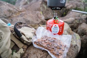 Josh from dialed in hunter's homemade bear chili on a bear hunt in arizona