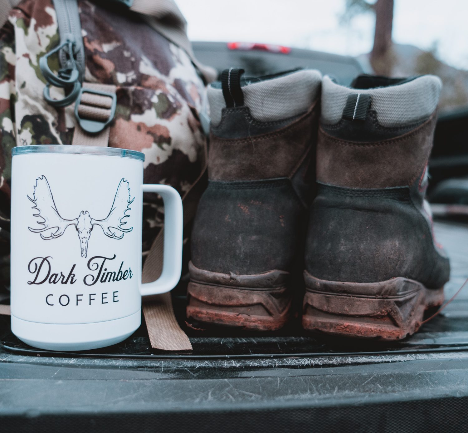 boot, coffee, and backpack on the tailgate and ready to scout