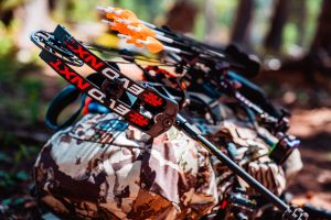 Bow and arrows strapped to a backpack in the backcountry of Colorado
