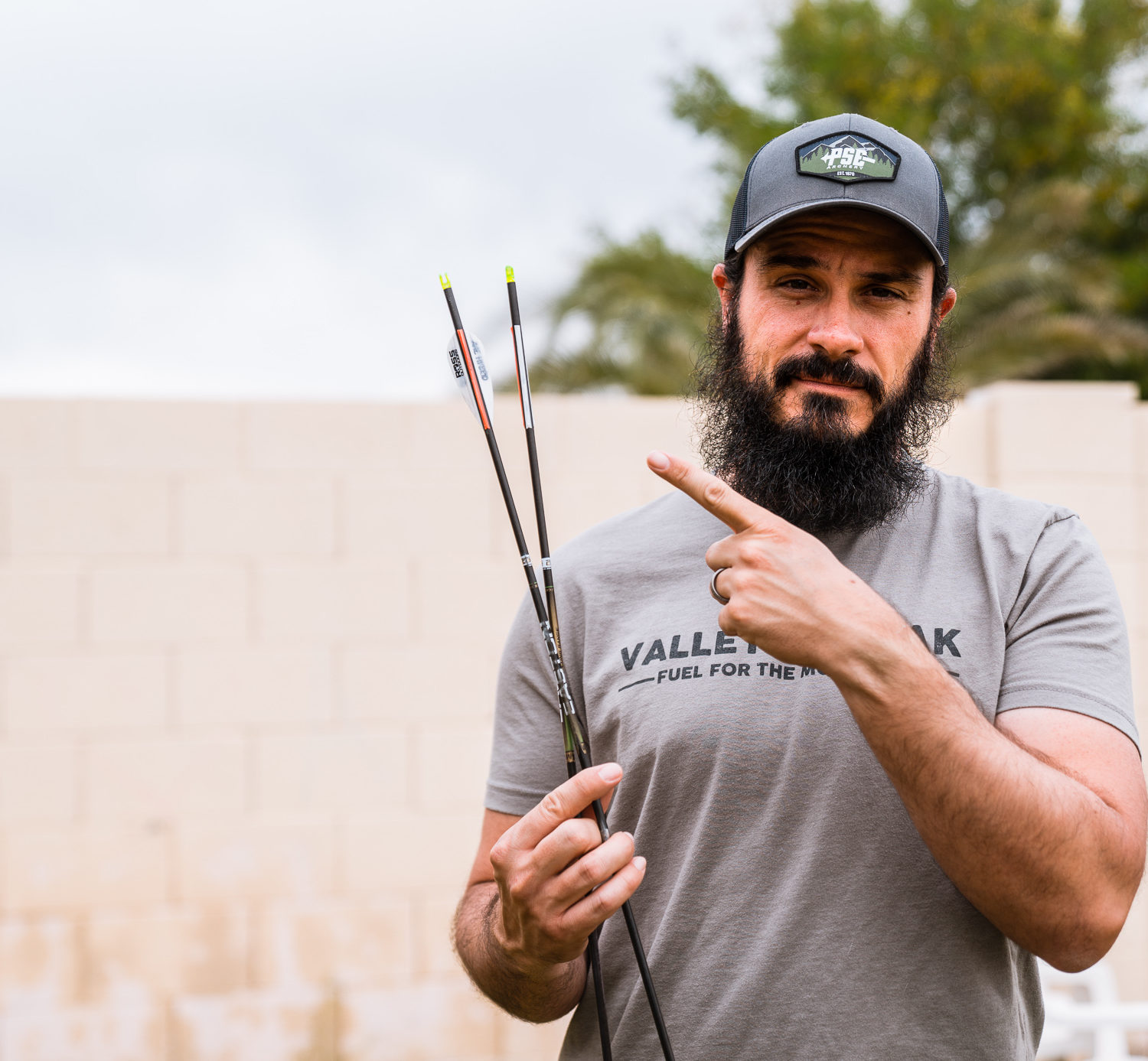 Josh Kirchner from Dialed in Hunter holding a bareshaft with fletched shaft