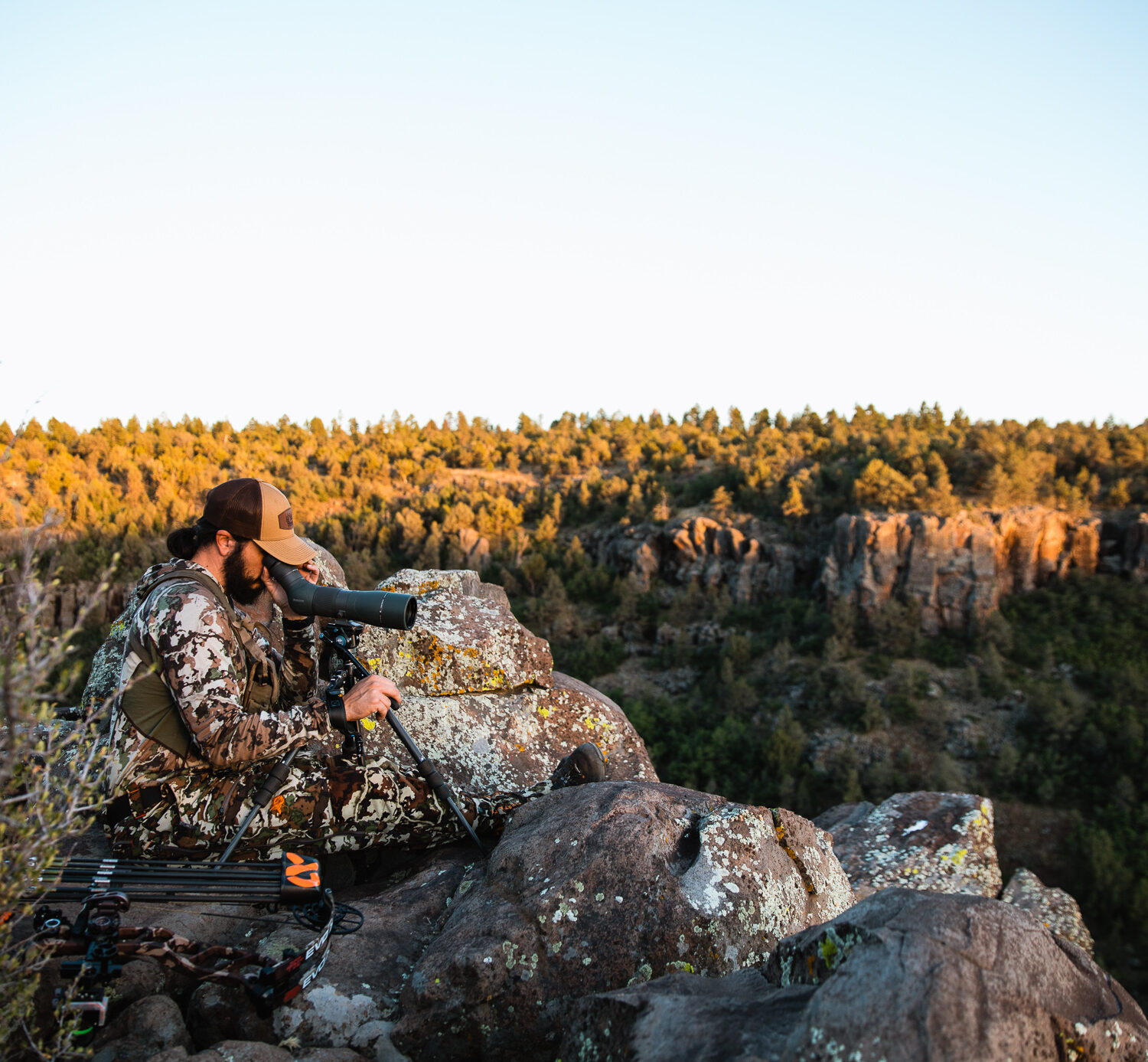 Josh Kirchner from Dialed in Hunter glassing with an angled spotting scope in the high desert of Arizona