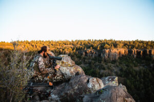 Josh Kirchner from Dialed in Hunter glassing with an angled spotting scope in the high desert of Arizona