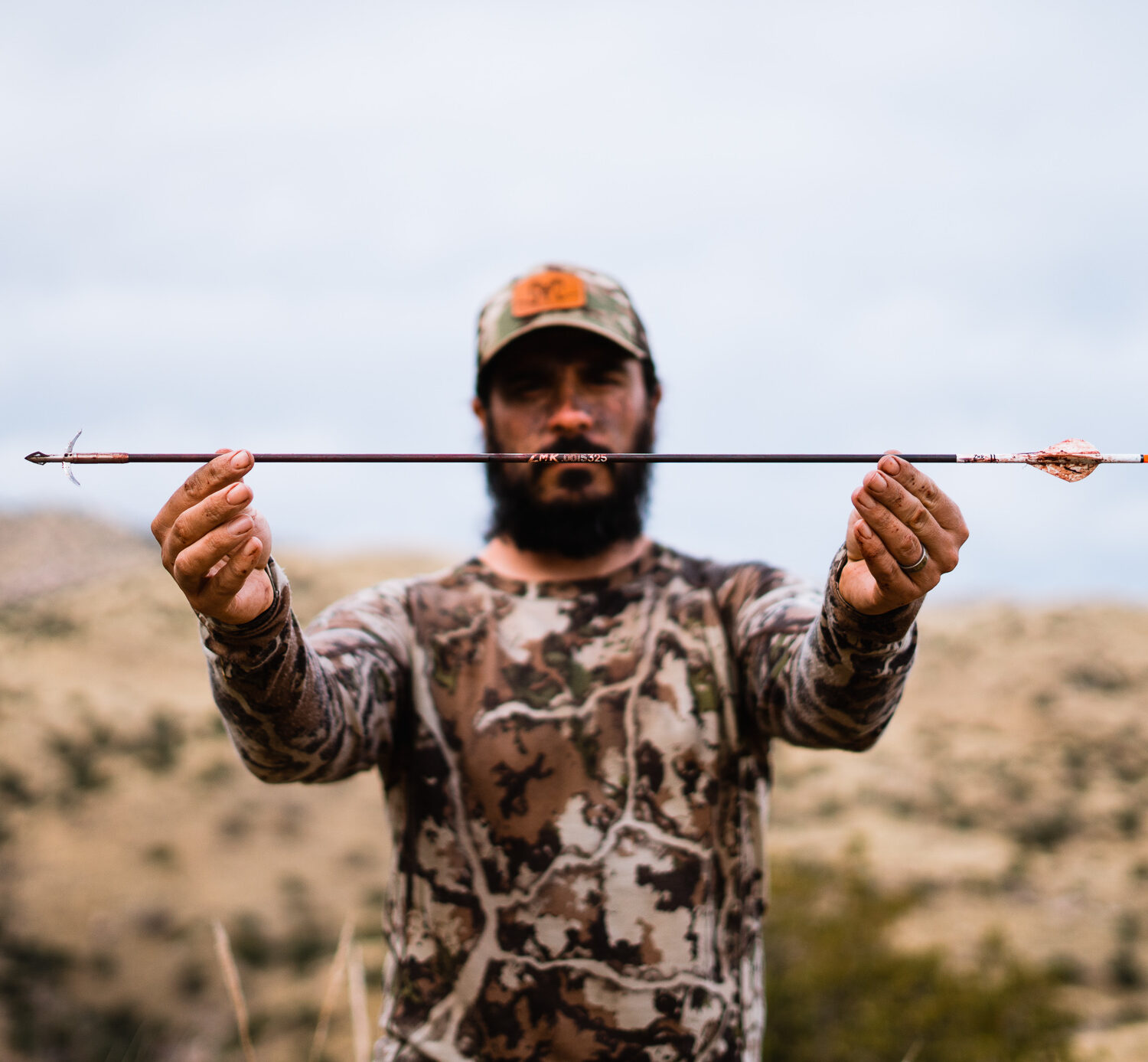 Josh Kirchner holding a Method Archery ZMR arrow after a successful coues deer hunt in Arizona