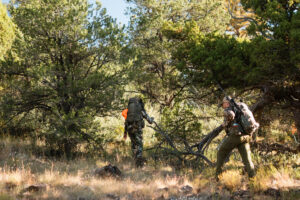 Josh Kirchner and hunting partner hiking on a bear hunt in Arizona