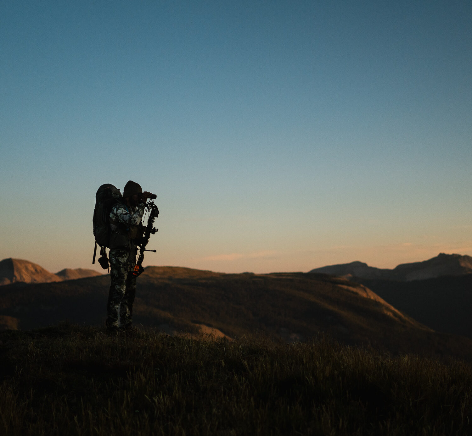 Josh Kirchner from Dialed in Hunter glassing for mule deer in the backcountry of Colorado