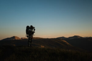 Josh Kirchner from Dialed in Hunter glassing for mule deer in the backcountry of Colorado
