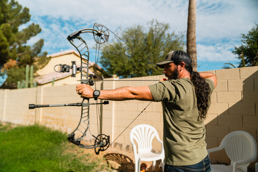 Josh Kirchner shooting his bow in the backyard