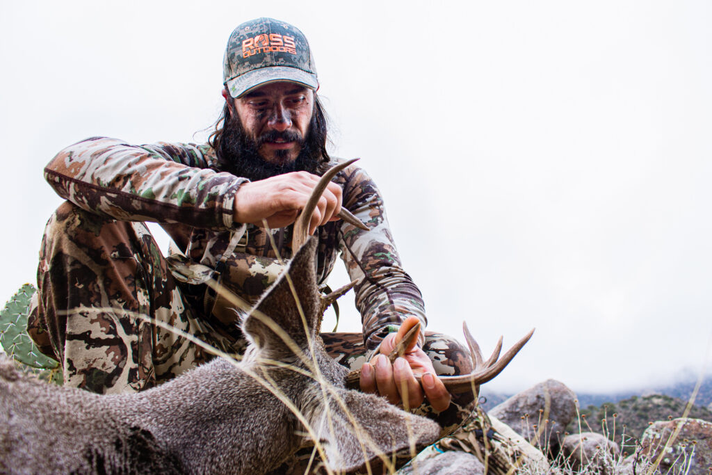 Josh Kirchner admiring the antlers of a coues buck he shot spot and stalk with his bow