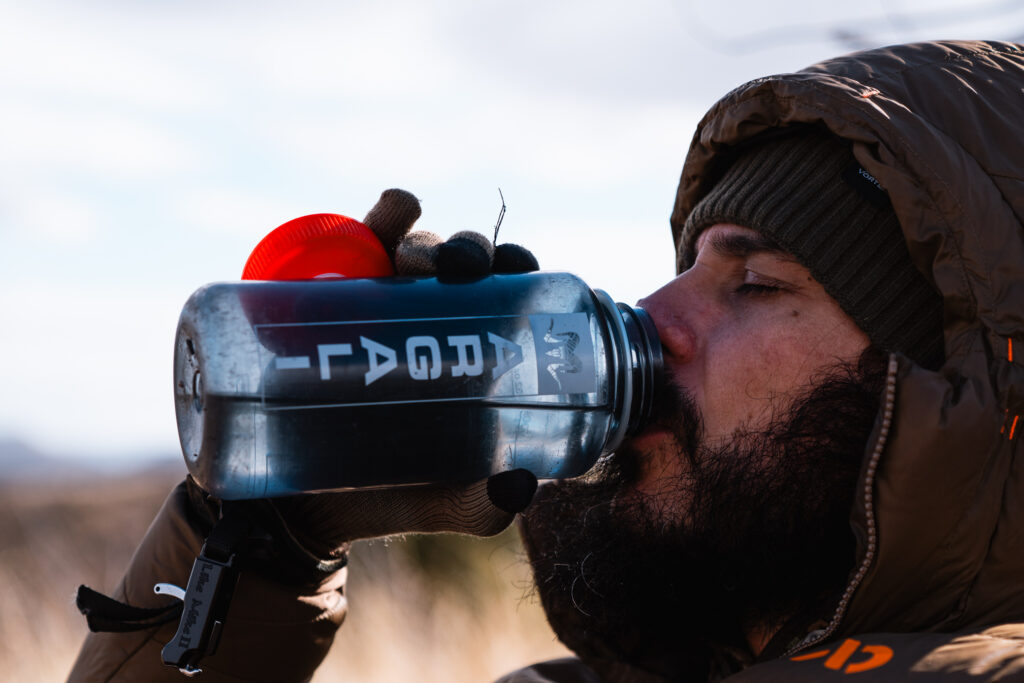Josh Kirchner from Dialed in Hunter drinking some hard earned water on a backpack hunt in Arizona