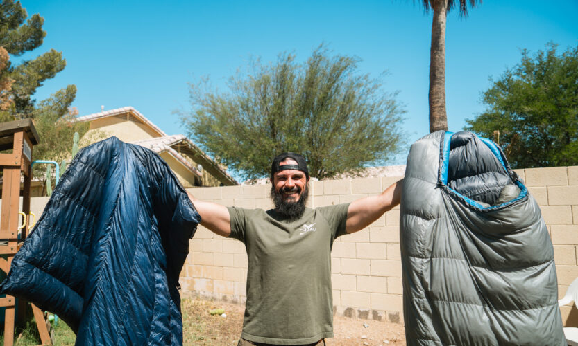 Josh Kirchner from Dialed in Hunter holding up a quilt and sleeping bag for backpack hunting