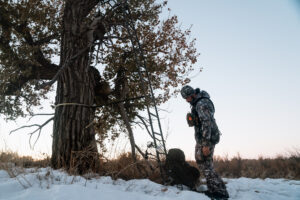 Josh Kirchner getting ready to climb into a tree stand while hunting whitetail deer in Colorado