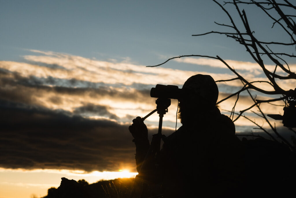 Josh Kirchner glassing for deer just as the sun was coming up on the horizon
