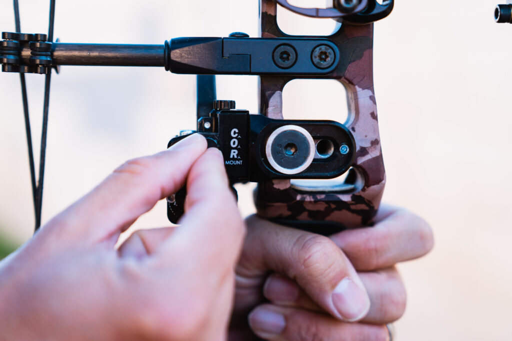 Josh Kirchner making a small adjustment to his arrow rest to achieve the proper tune