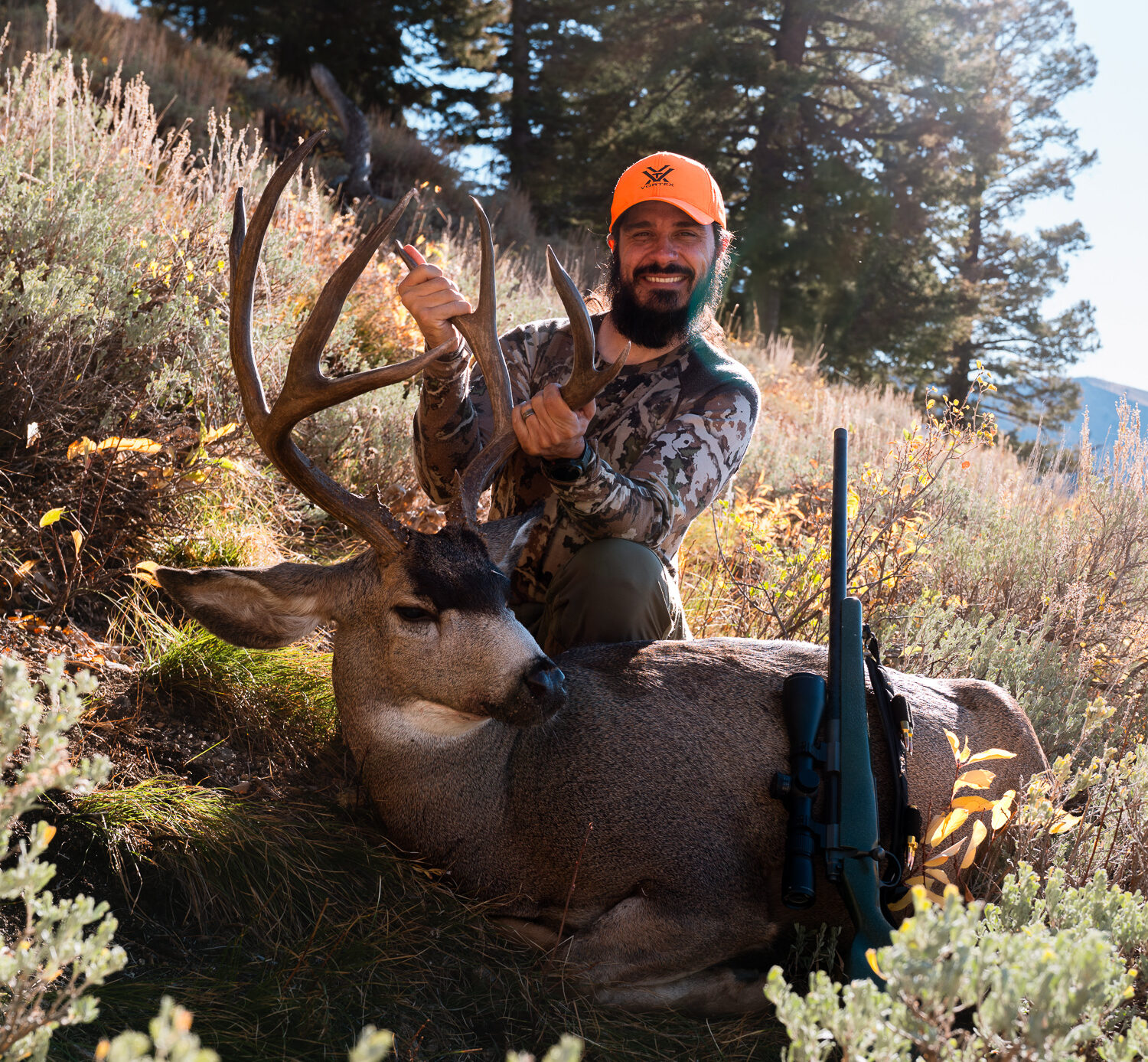 Josh Kirchner with an October mule deer he harvested in a mountain state after diligent e-scouting