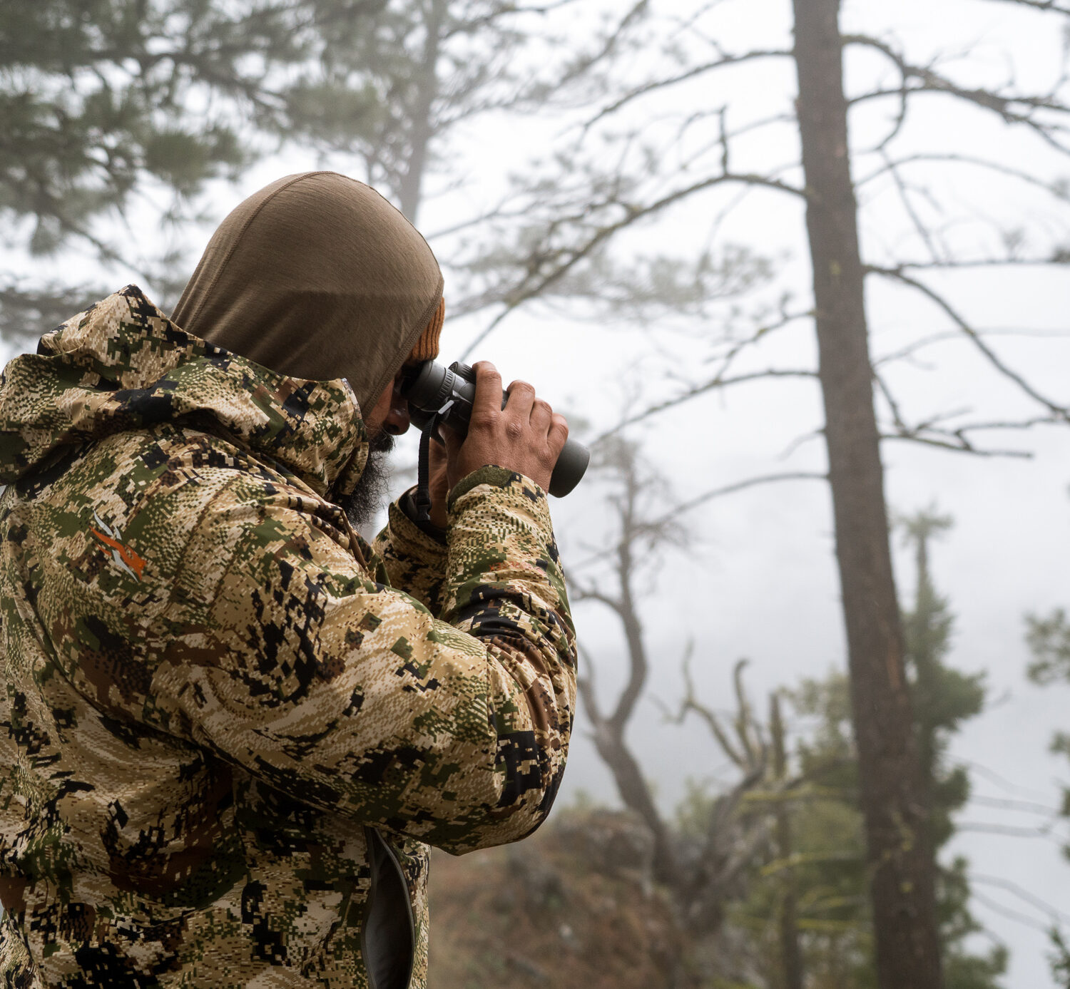 Josh Kirchner from Dialed in Hunter glassing for bears with binoculars during the spring time