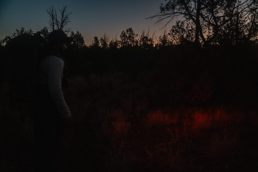 Josh Kirchner hiking through the dark with his headlamp during bear season